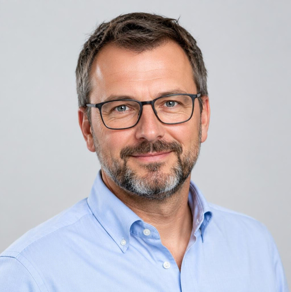 Studio portrait of a Belgian man with glasses and a beard